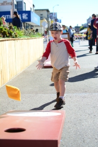 Jack Latourelle, 3, plays a bean bag toss game at the Clement Street Farmer's Market in San Francisco, Calif., on Sunday, Sept. 15, 2013.